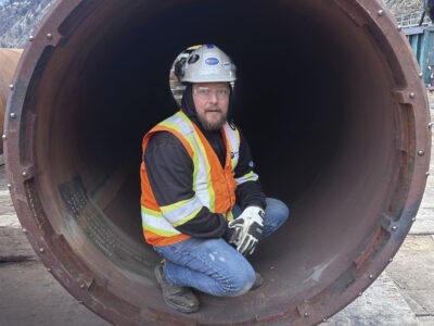 Mitch, crouched in large pipe