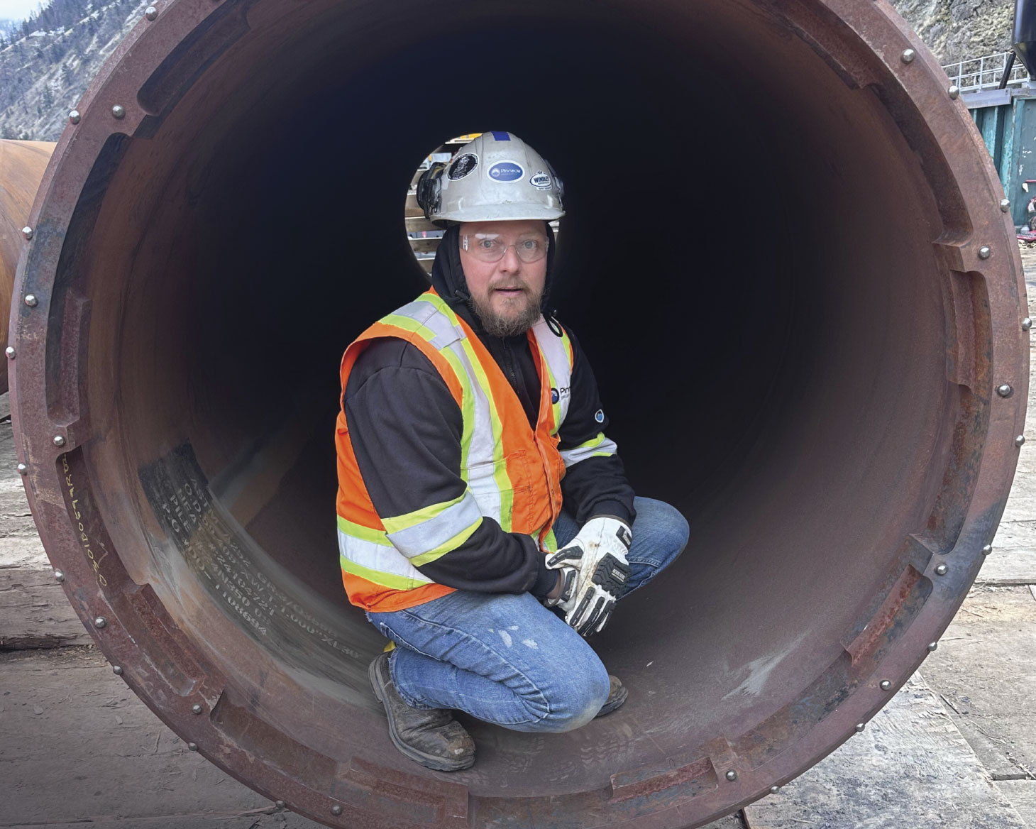 Mitch, crouched in large pipe
