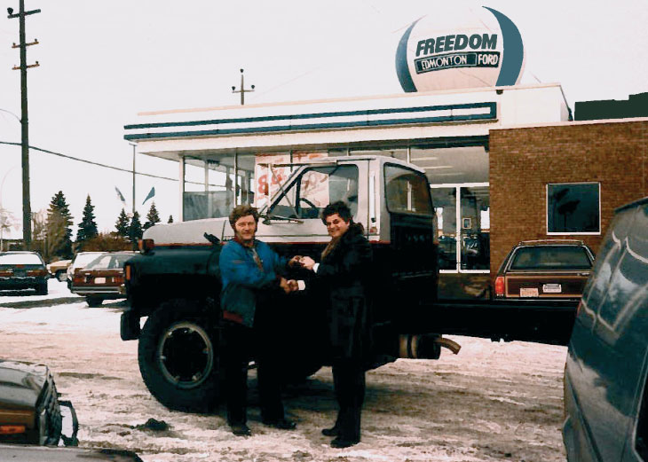 Joey M. being handed keys to truck in sales lot