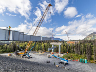 Aerial view of a Leibherr 1300 crane on the construction site with mountain landscape