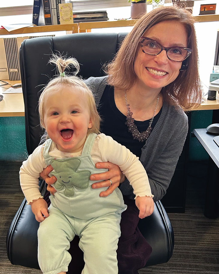 Carol Domitric holding smiling child on lap