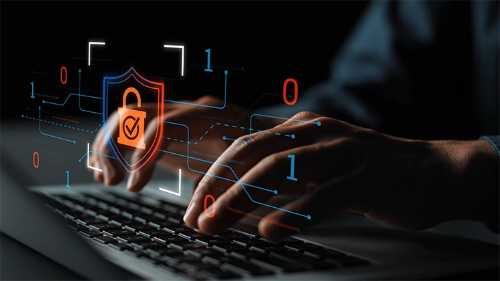 Hands on keyboard with cyber security HUD graphic overlay
