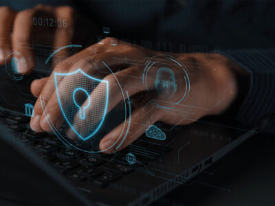 Hands on keyboard with cyber security HUD graphic overlay