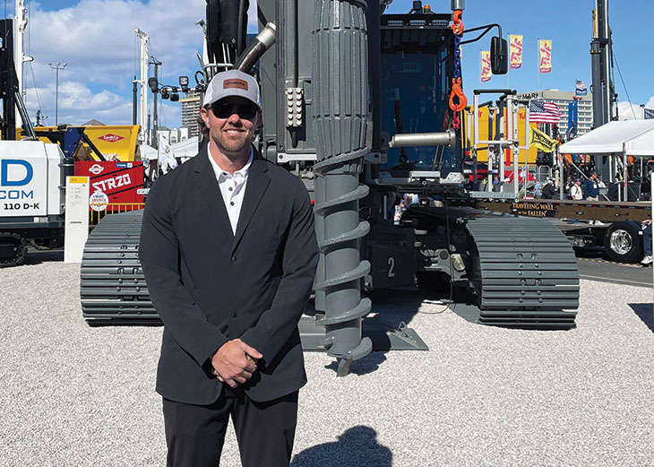 Andrew McKnight, posing for photo in front of Liebherr drilling machine