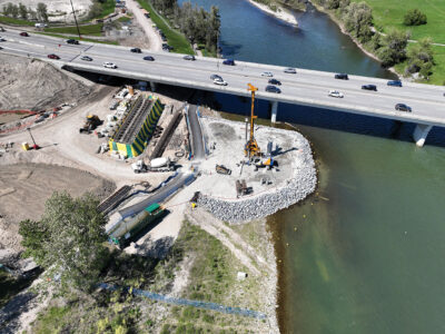 A Bauer BG28 drill rig installing reinforced concrete piles as part of the twinning of the Ivor Strong Bridge over the Bow River in June 2024