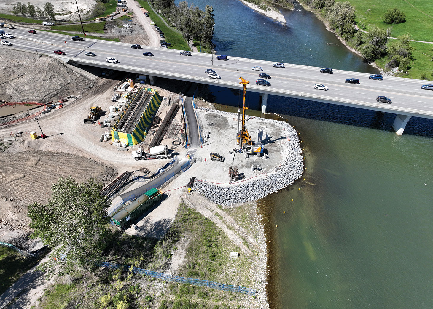 A Bauer BG28 drill rig installing reinforced concrete piles as part of the twinning of the Ivor Strong Bridge over the Bow River in June 2024