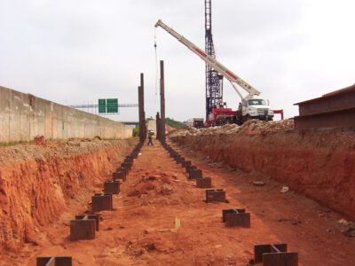 Steel H-piles installed along an excavated highway right-of-way