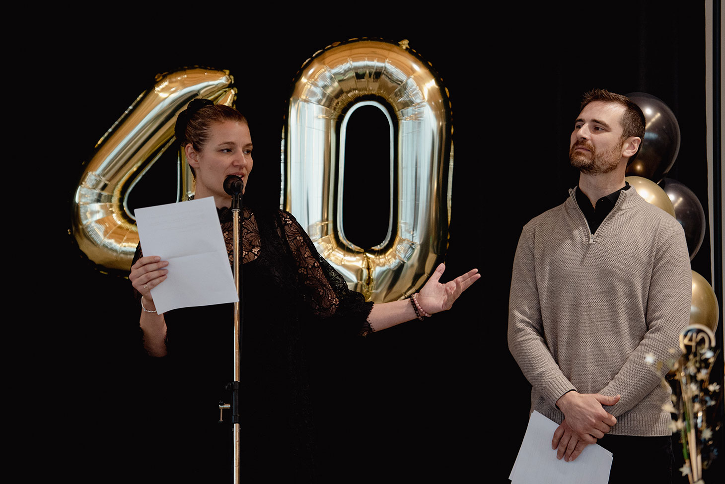 Audrey and Frank Gilbert on stage, addressing crowd