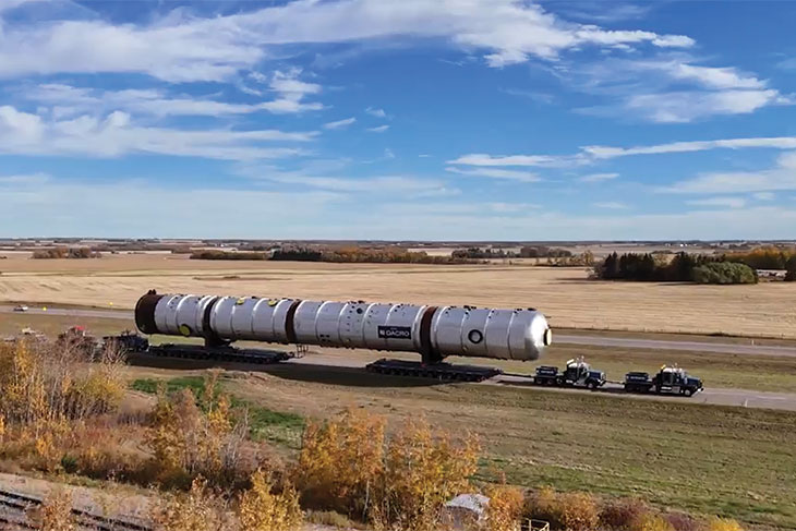 Truck carrying an oversized load on a lonely highway