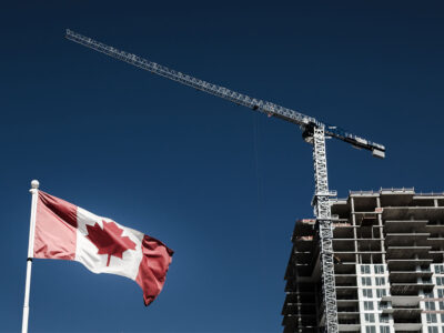 Canadian flag with building construction in the background