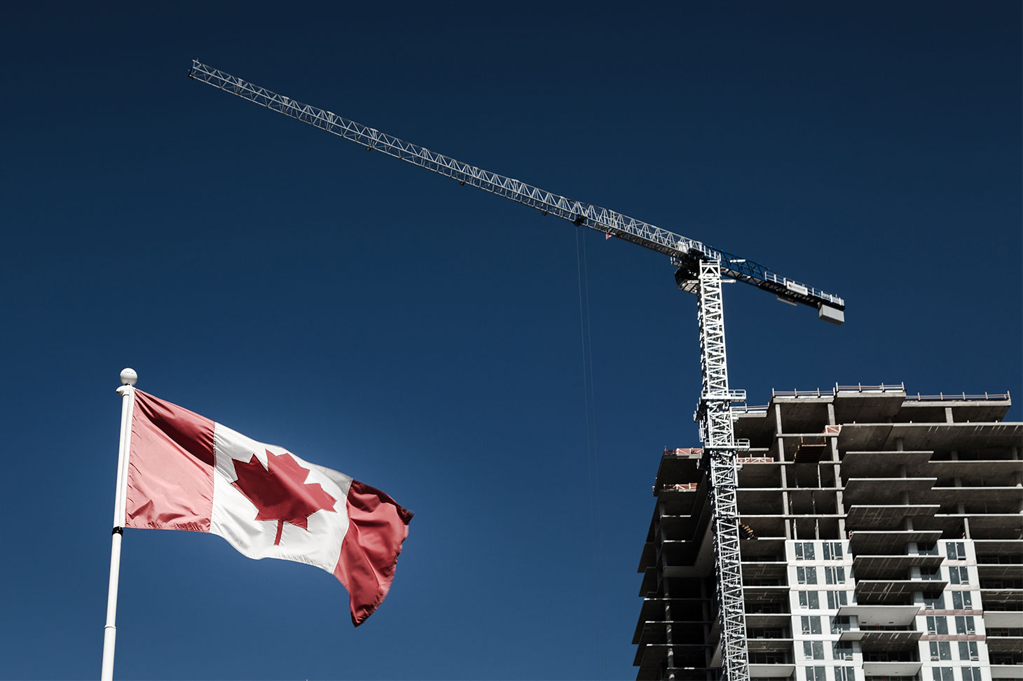 Canadian flag with building construction in the background