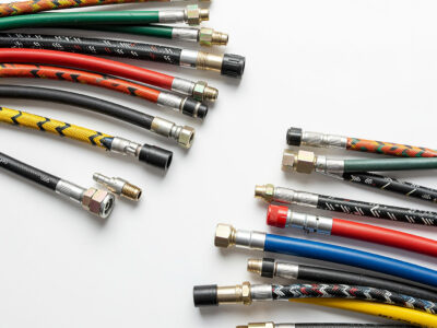 multi-colored hydraulic hose assemblies on white background